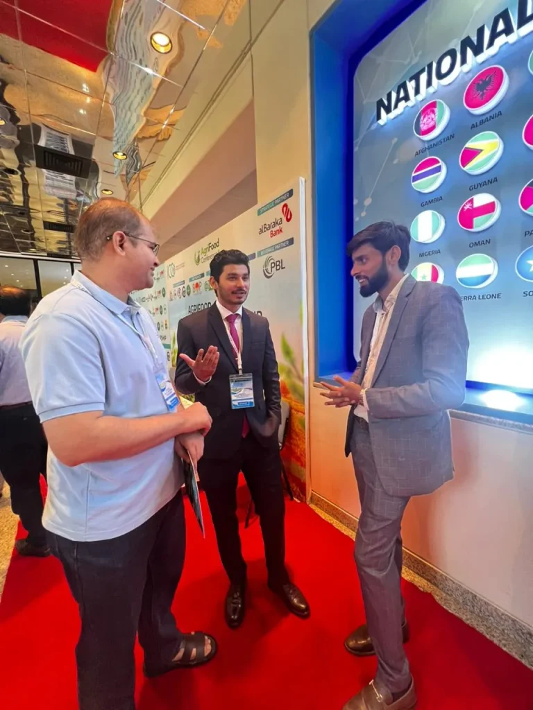 Two men talking in front of an exhibition booth at the ICCD event