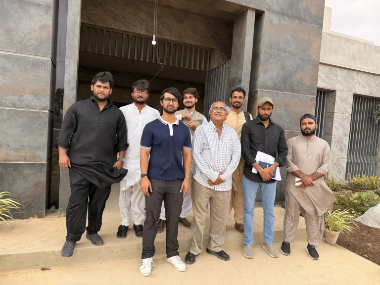 Group of men posing together outside a building at the OBOR event